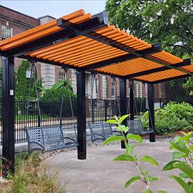 bench porch swing gliders hanging from an orange shelter