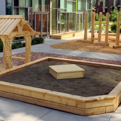 YMCA Natural Play sandbox and play house