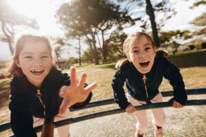 kids in playground reaching out