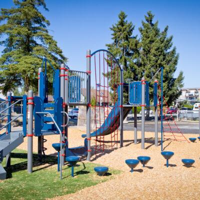 blue, gray and red playground on turf