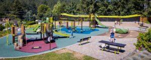 green and brown playground with long zipline