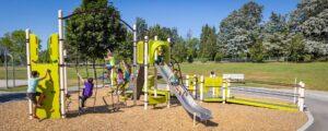 green school playground with a metal slide