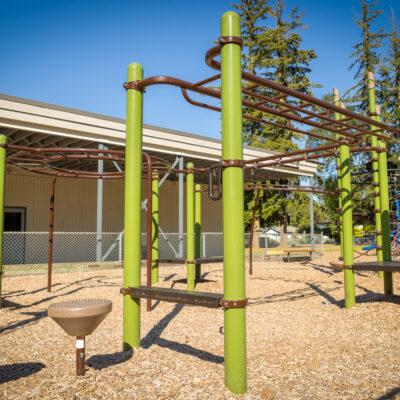 green and brown playground on engineered wood fibre (EWF) surfacing