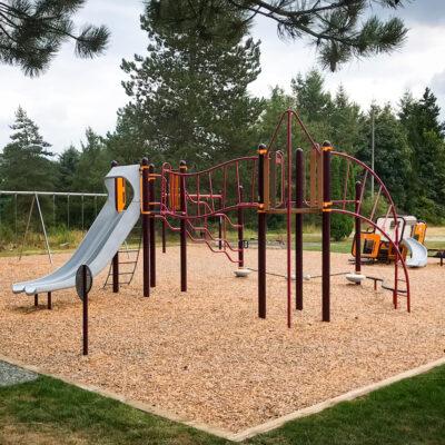 red, yellow & gray playground with engineered wood fibre (EWF) surfacing