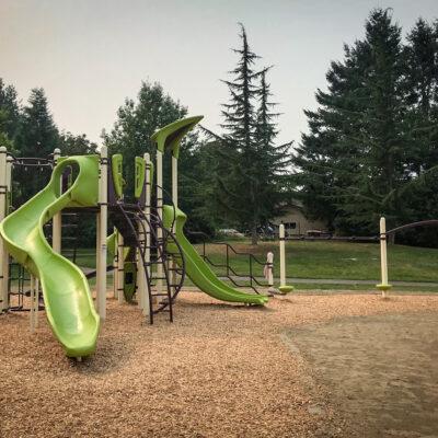 green, brown and light yellow playground on engineered wood fibre surfacing (EWF)