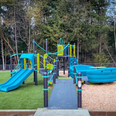 blue and green playground on artificial grass & engineered wood fibre (EWF) surfacing