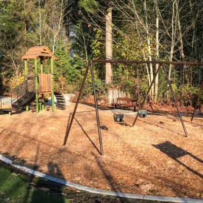 Brown, green and black playground on engineered wood fibre (EWF) surfacing