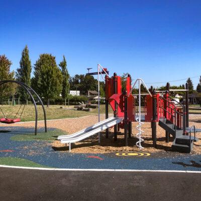 white, red and black playground on marathon pour-in-place (PIP) rubber & engineered wood fibre (EWF) surfacing