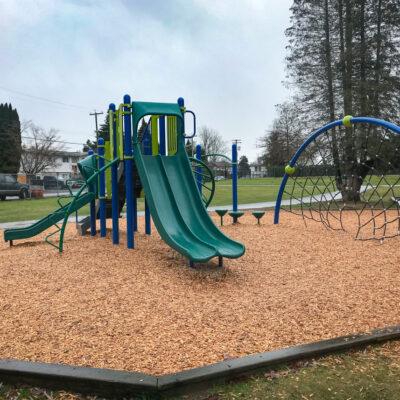 green & blue playground on engineered wood fibre (EWF) surfacing