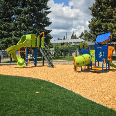 Orange, blue and green playground on engineered wood fibre (EWF) surfacing