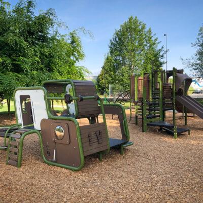 green and brown playground on engineered wood fibre (EWF) surfacing