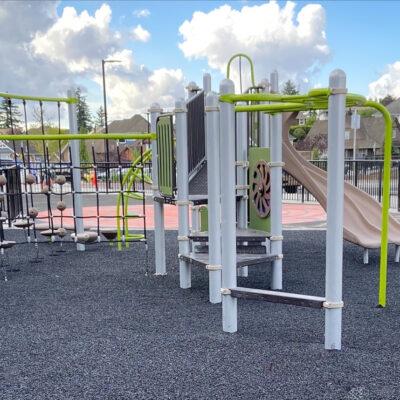 green, brown and gray playground on pour in place (PIP) Rubber