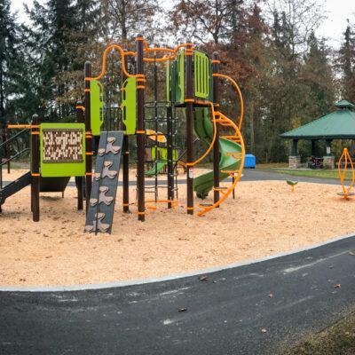 brown, green and orange playground on engineered wood fibre (EWF) surfacing