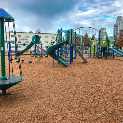 dark green, light green and blue playground on engineered wood fibre (EWF) surfacing