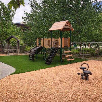 Brown, green & black plays ground with engineered wood fibre (EWF) and rymar artificial grass surfacing