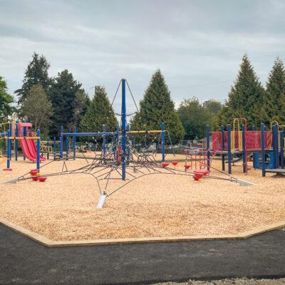 red, blue and yellow playground on engineered wood fibre (EWF) surfacing