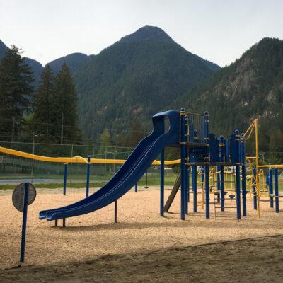 blue and yellow playground on engineered wood fibre (EWF) surfacing